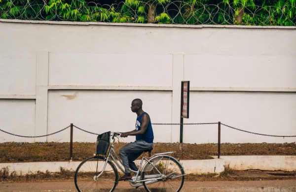 Man rides bicycle in Accra, Ghana