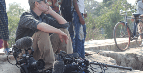 Filmmaker Ben Kalina, director of the new documentary “Plan C for Civilization,” sits with his film equipment while shooting in Gabura, Satkhira District, in Bangladesh.