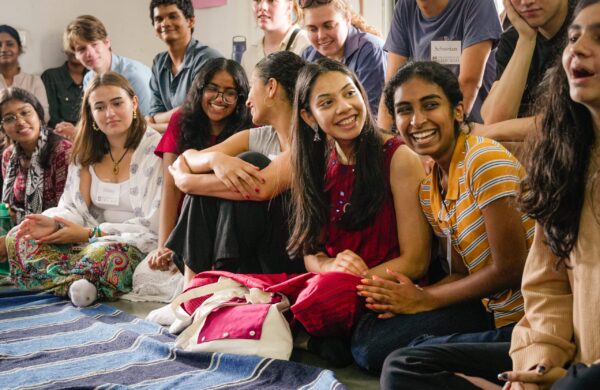 students hold cloth and smile